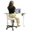 model sitting at ViVi Vergo stool in front of stand up desk