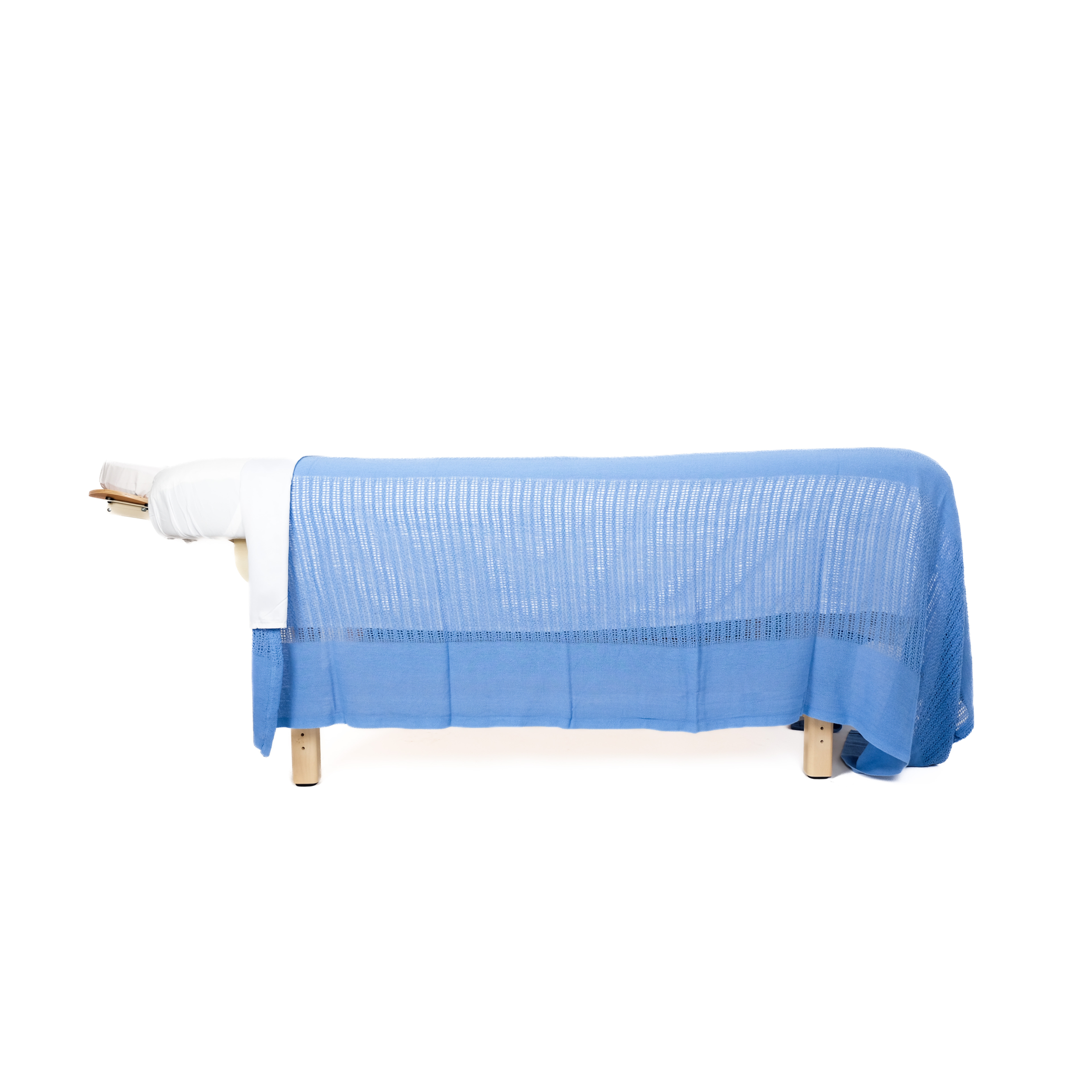 blue thermal cotton blanket on massage table