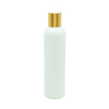 white massage oil bottle with gold cap